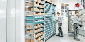 roll of sheet steel, transported by crane at the factory