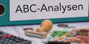 roll of sheet steel, transported by crane at the factory