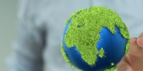 roll of sheet steel, transported by crane at the factory