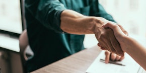 roll of sheet steel, transported by crane at the factory