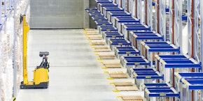 roll of sheet steel, transported by crane at the factory