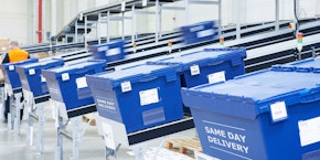 roll of sheet steel, transported by crane at the factory