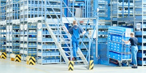 roll of sheet steel, transported by crane at the factory