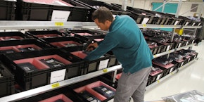 roll of sheet steel, transported by crane at the factory